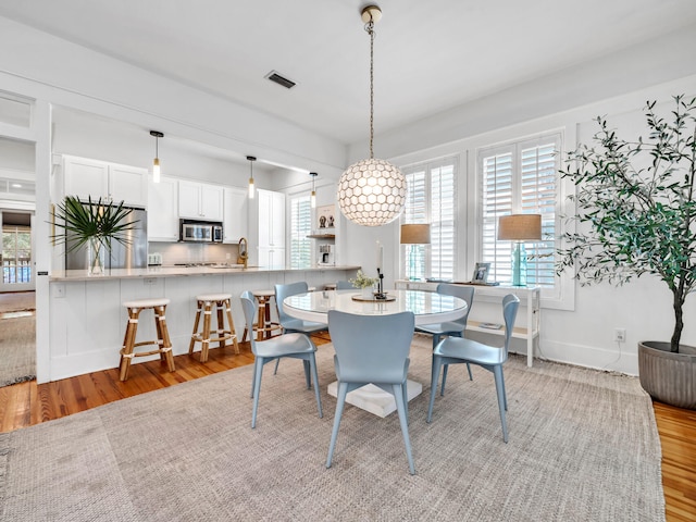 dining room with light hardwood / wood-style flooring