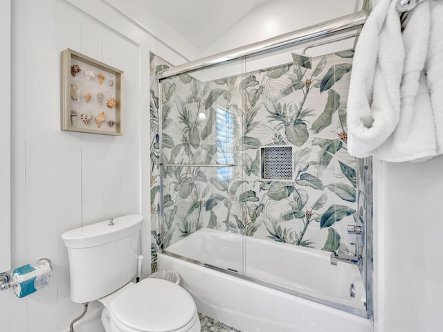 bathroom featuring toilet, vaulted ceiling, and shower / bath combination with glass door