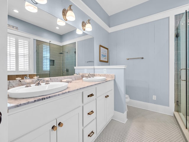 bathroom featuring vanity, a shower with shower door, toilet, and tile patterned flooring