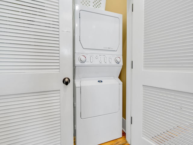 clothes washing area featuring stacked washer and dryer