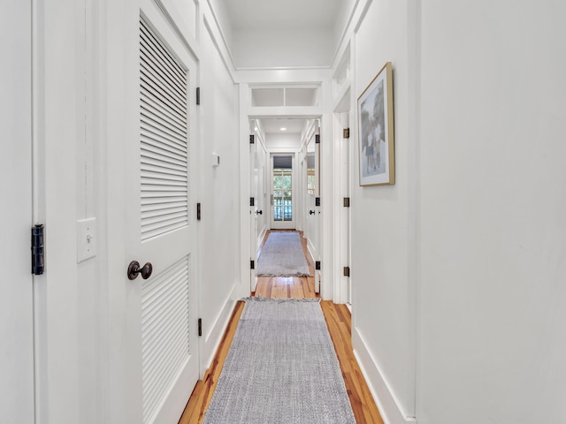 hall with hardwood / wood-style floors