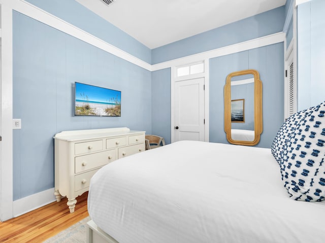 bedroom with a closet and light hardwood / wood-style floors