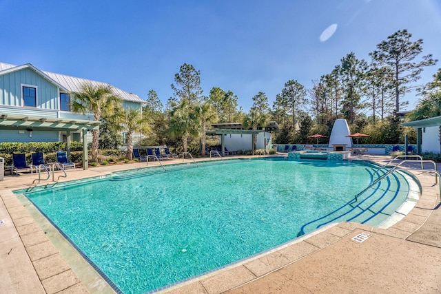 view of swimming pool featuring a patio and a pergola