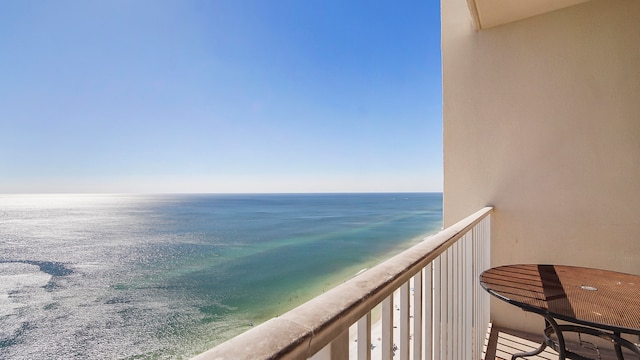 balcony featuring a water view and a beach view