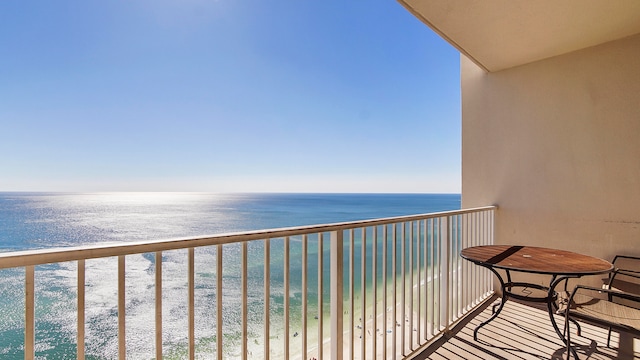 balcony with a water view and a beach view