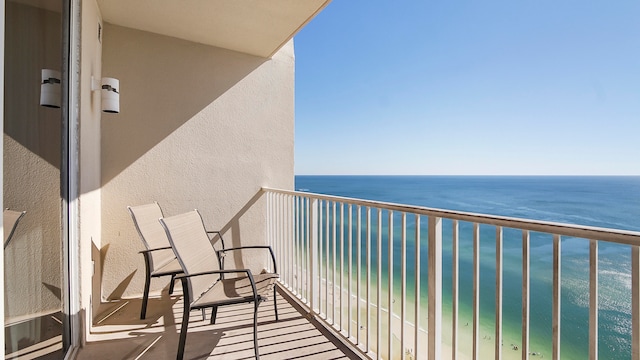 balcony with a water view and a beach view