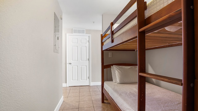 unfurnished bedroom featuring electric panel and light tile patterned flooring