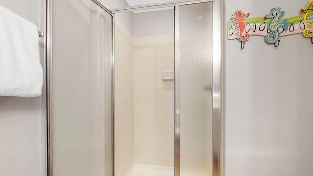 bathroom with a shower with door