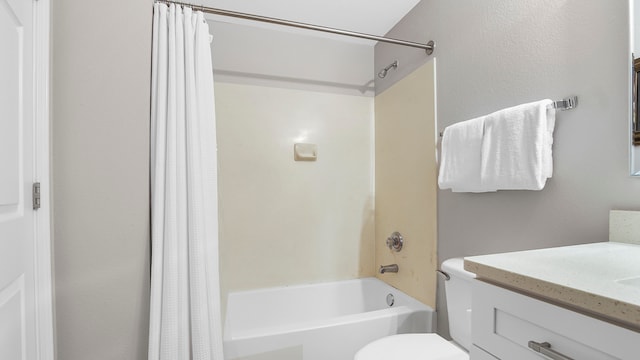 full bathroom with toilet, shower / tub combo with curtain, and vanity