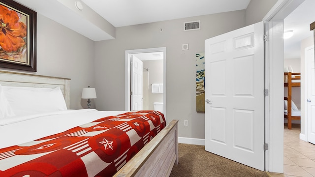 carpeted bedroom with ensuite bath