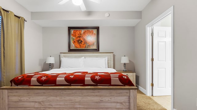 bedroom with ceiling fan and light carpet