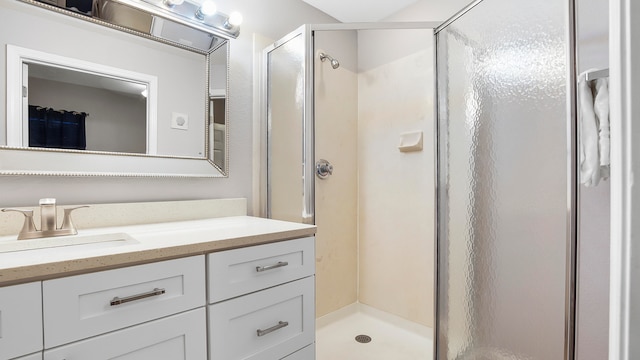 bathroom featuring vanity and a shower with shower door