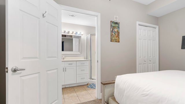 tiled bedroom with connected bathroom