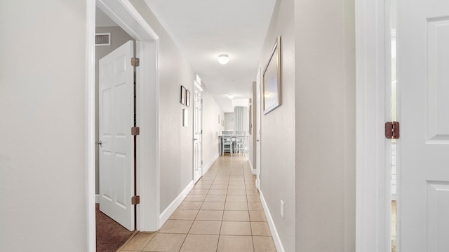 hall featuring light tile patterned floors