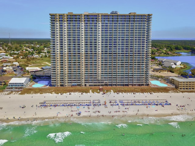 drone / aerial view featuring a water view and a view of the beach