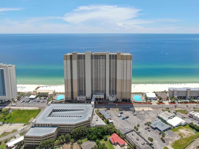 bird's eye view featuring a water view and a beach view