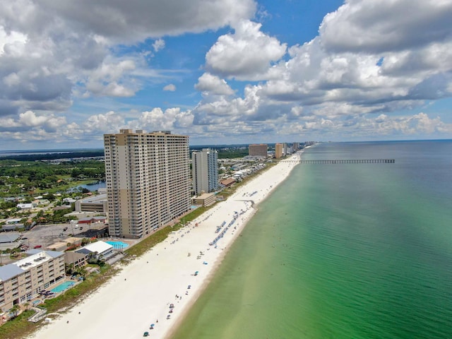 birds eye view of property with a water view and a view of the beach