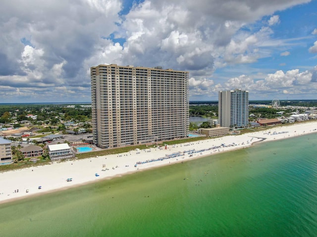 drone / aerial view featuring a water view and a view of the beach