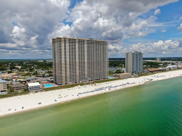 birds eye view of property with a water view and a beach view