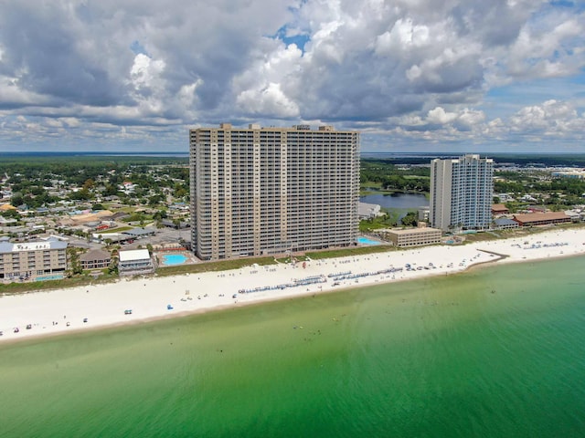 bird's eye view with a water view and a beach view