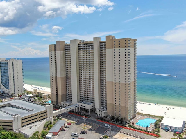 bird's eye view featuring a water view and a beach view