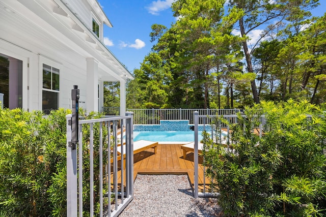 view of swimming pool featuring a deck and pool water feature