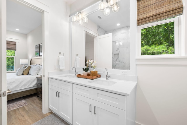 bathroom featuring vanity, hardwood / wood-style flooring, a healthy amount of sunlight, and walk in shower