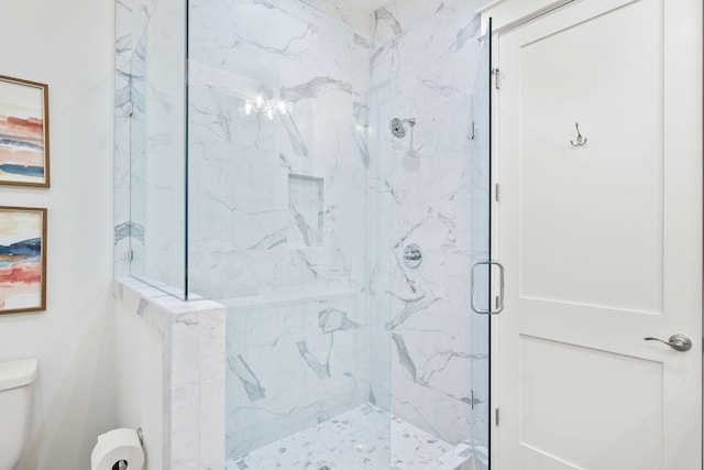 bathroom featuring toilet and an enclosed shower