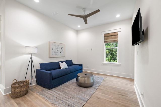 living room featuring ceiling fan and hardwood / wood-style floors