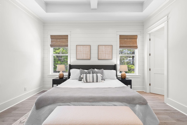 bedroom with ornamental molding and hardwood / wood-style floors