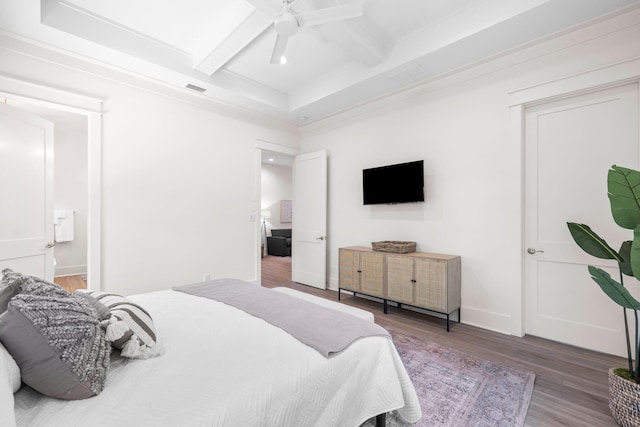 bedroom with coffered ceiling, hardwood / wood-style flooring, beam ceiling, ensuite bathroom, and ceiling fan