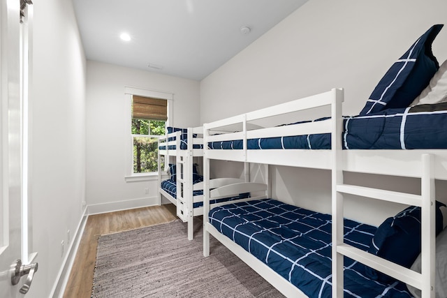 bedroom featuring lofted ceiling and hardwood / wood-style floors