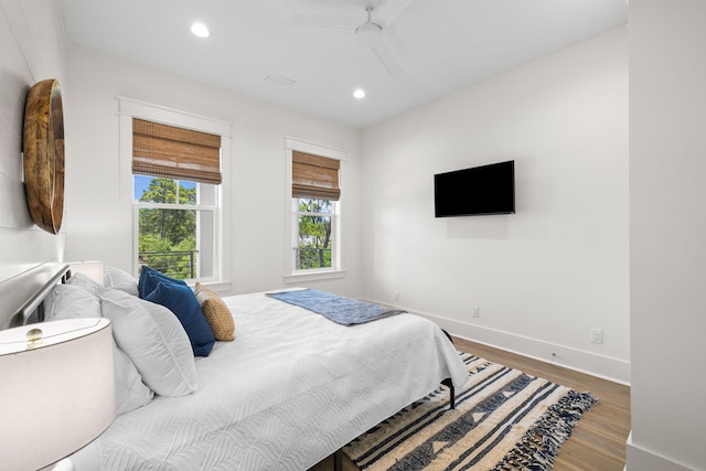 bedroom with ceiling fan and wood-type flooring