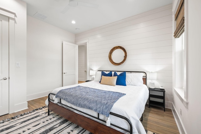 bedroom with dark wood-type flooring and ceiling fan