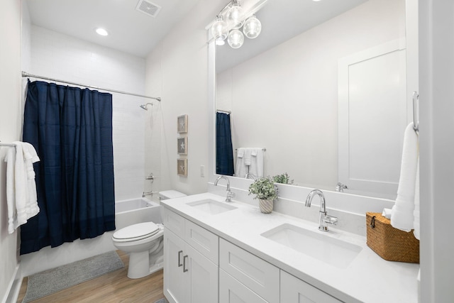 full bathroom with toilet, vanity, shower / bath combo with shower curtain, and wood-type flooring