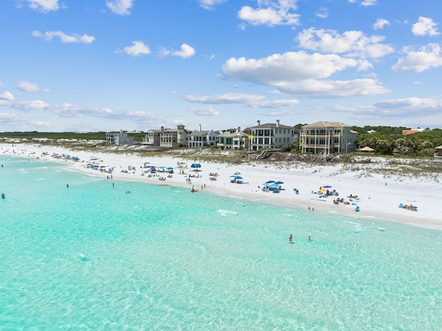 drone / aerial view with a water view and a beach view