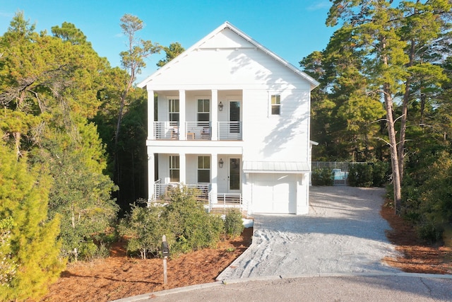 greek revival inspired property with a garage and a balcony