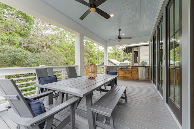 wooden terrace featuring an outdoor kitchen, a grill, and ceiling fan