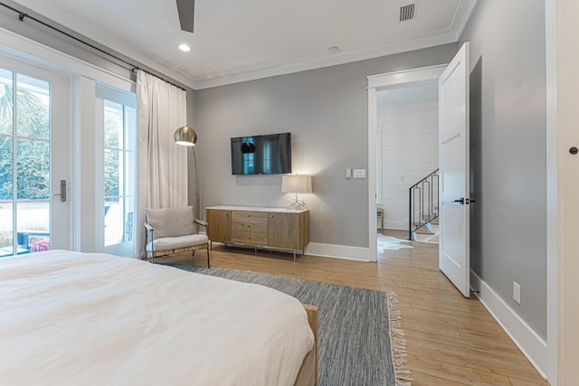 bedroom featuring access to exterior, light hardwood / wood-style flooring, multiple windows, and ceiling fan