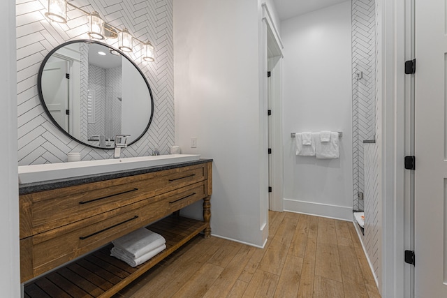 bathroom with vanity, hardwood / wood-style flooring, and tile walls