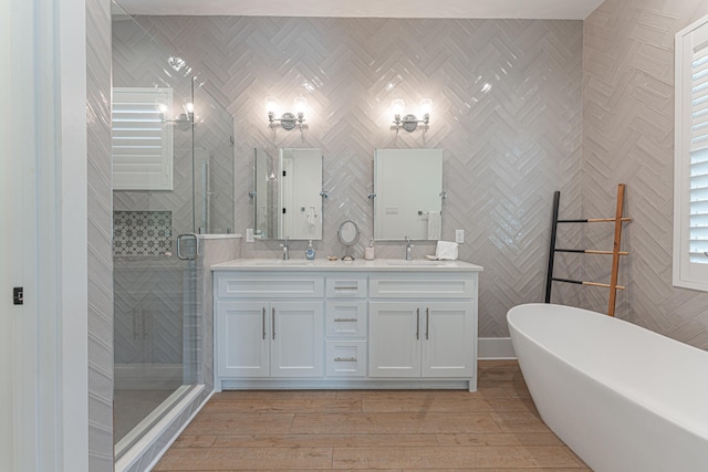 bathroom with vanity, separate shower and tub, and hardwood / wood-style floors