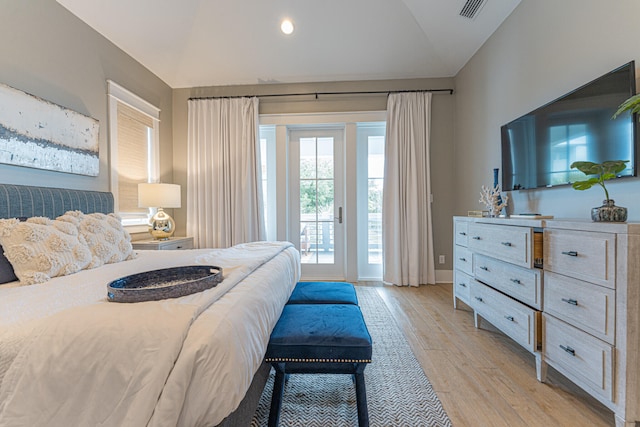 bedroom with light hardwood / wood-style flooring, access to exterior, and vaulted ceiling