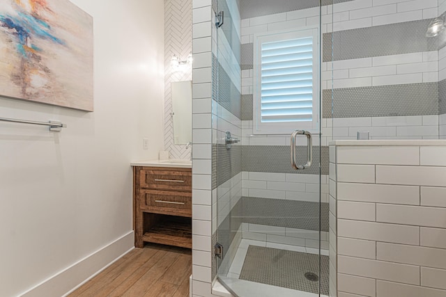 bathroom featuring vanity, wood-type flooring, and an enclosed shower