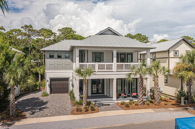 view of front of house featuring a balcony and a garage