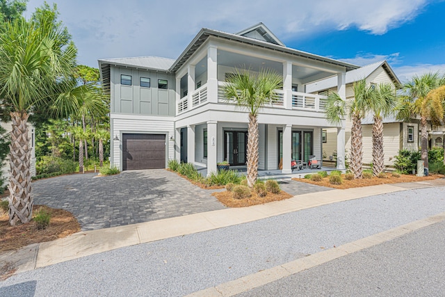 view of front facade with a balcony and a garage