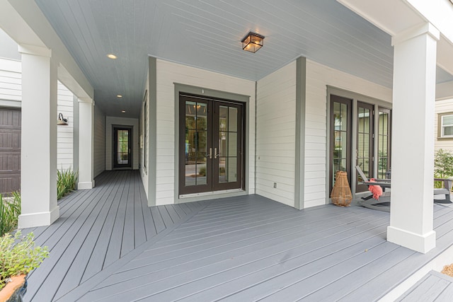 wooden deck with french doors and a garage