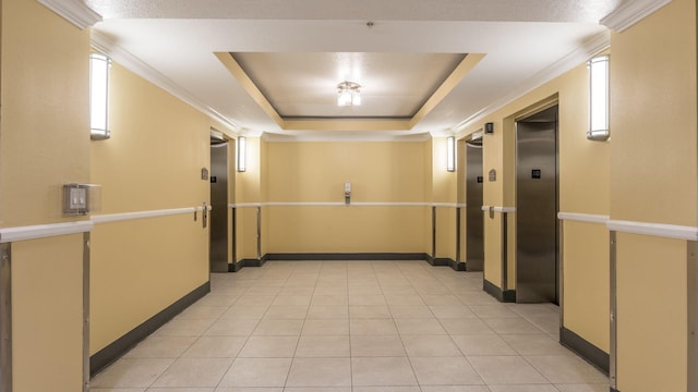 corridor featuring crown molding, elevator, light tile patterned floors, and a raised ceiling