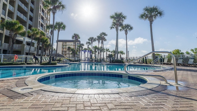 view of pool with a hot tub