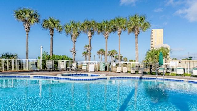 view of swimming pool featuring a community hot tub