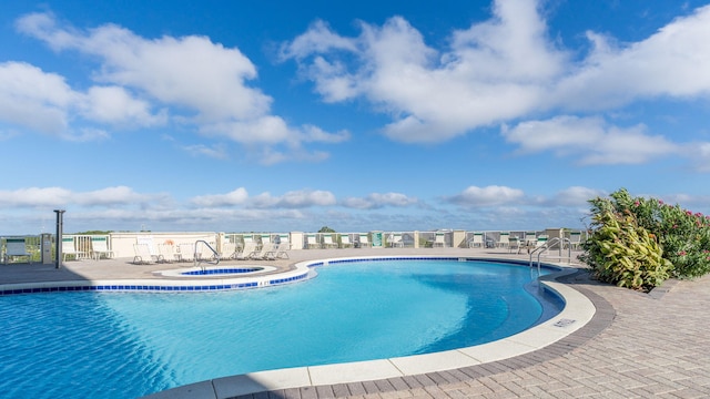 view of pool featuring a community hot tub and a patio